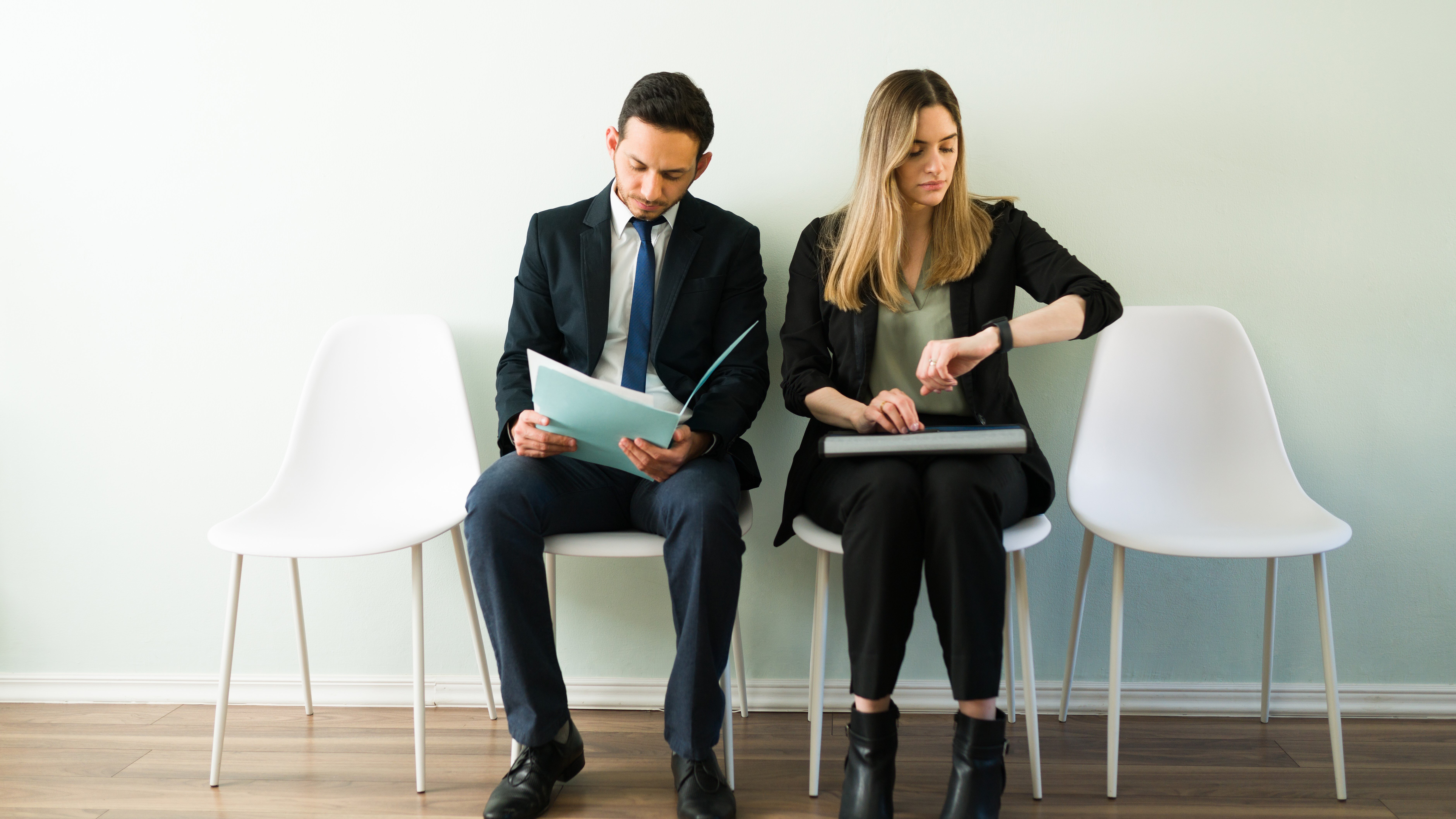 beautiful-caucasian-woman-looking-her-watch-waiting-job-interview-latin-man-woman-suits-recruitment-office